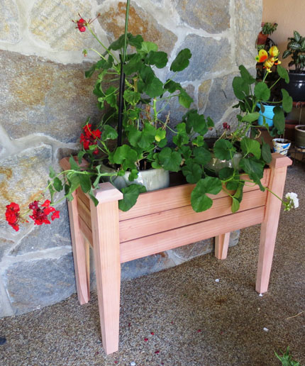 Elevated Planter Box in Position Holding Vases and Plants