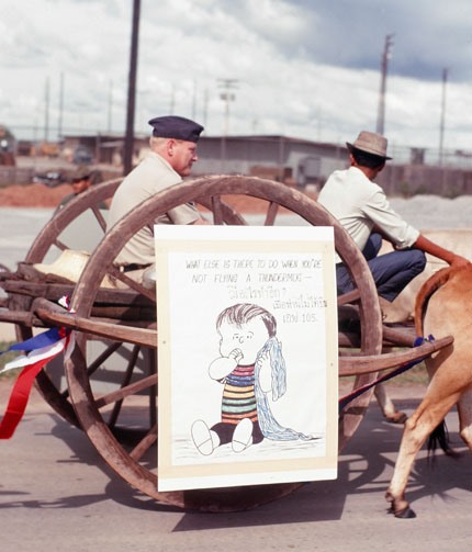 Ox Cart with Officer and Cartoon Sign